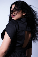 Designer black midi dress with tulip sleeves and removable tulle skirt, side view