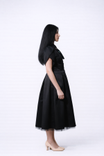 Designer black midi dress with tulip sleeves and removable tulle skirt, side view
