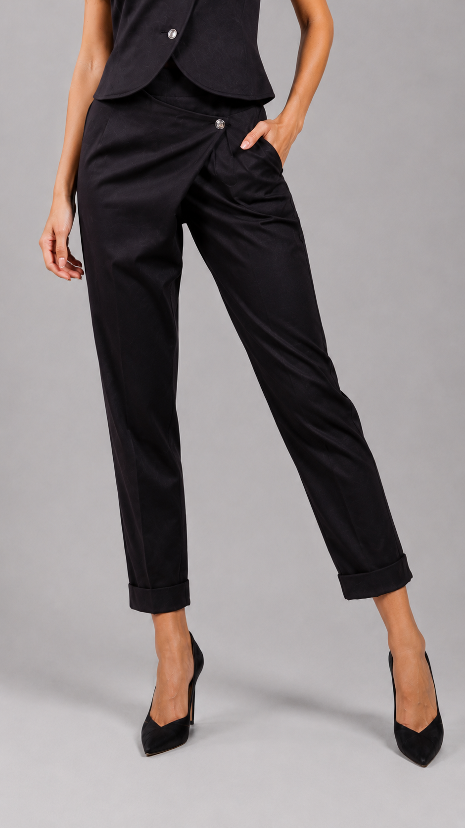 Elegant black asymmetric trousers with high waist and above-ankle length