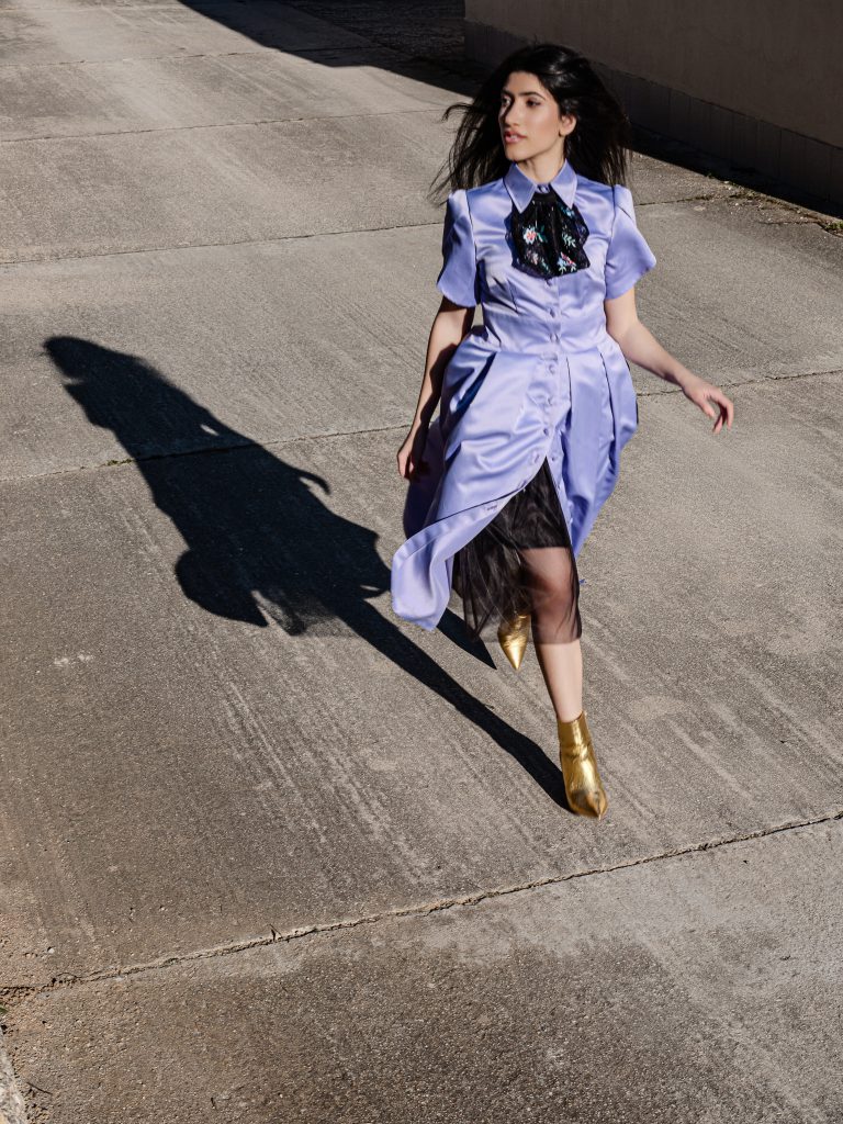 Model wearing lavender open back midi dress with detachable jabot and separate black tulle skirt