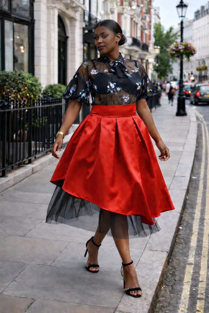 Red pleated midi skirt with asymmetric satin hem and soft black tulle underlayer