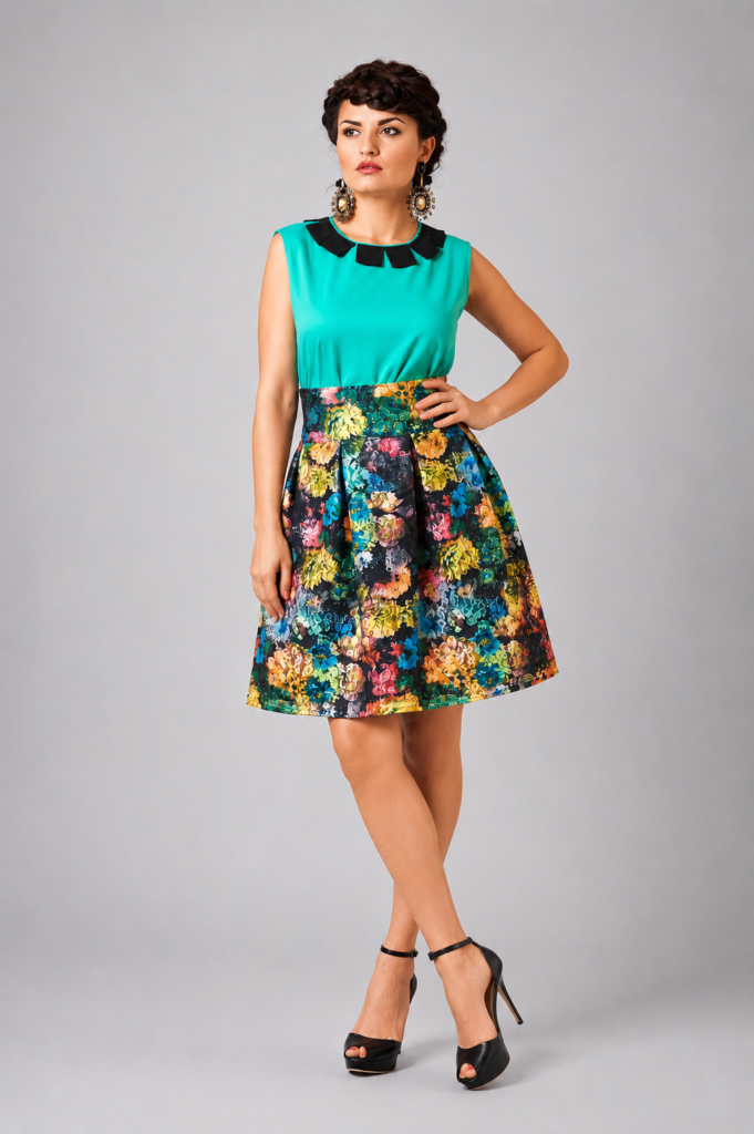 Woman wearing floral lace mini skirt with wide waistband and pleated silhouette by BIBI SAKALIEVA.