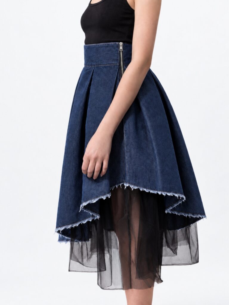 Model wearing BIBI SAKALIEVA asymmetric pleated indigo denim midi skirt with black tulle
