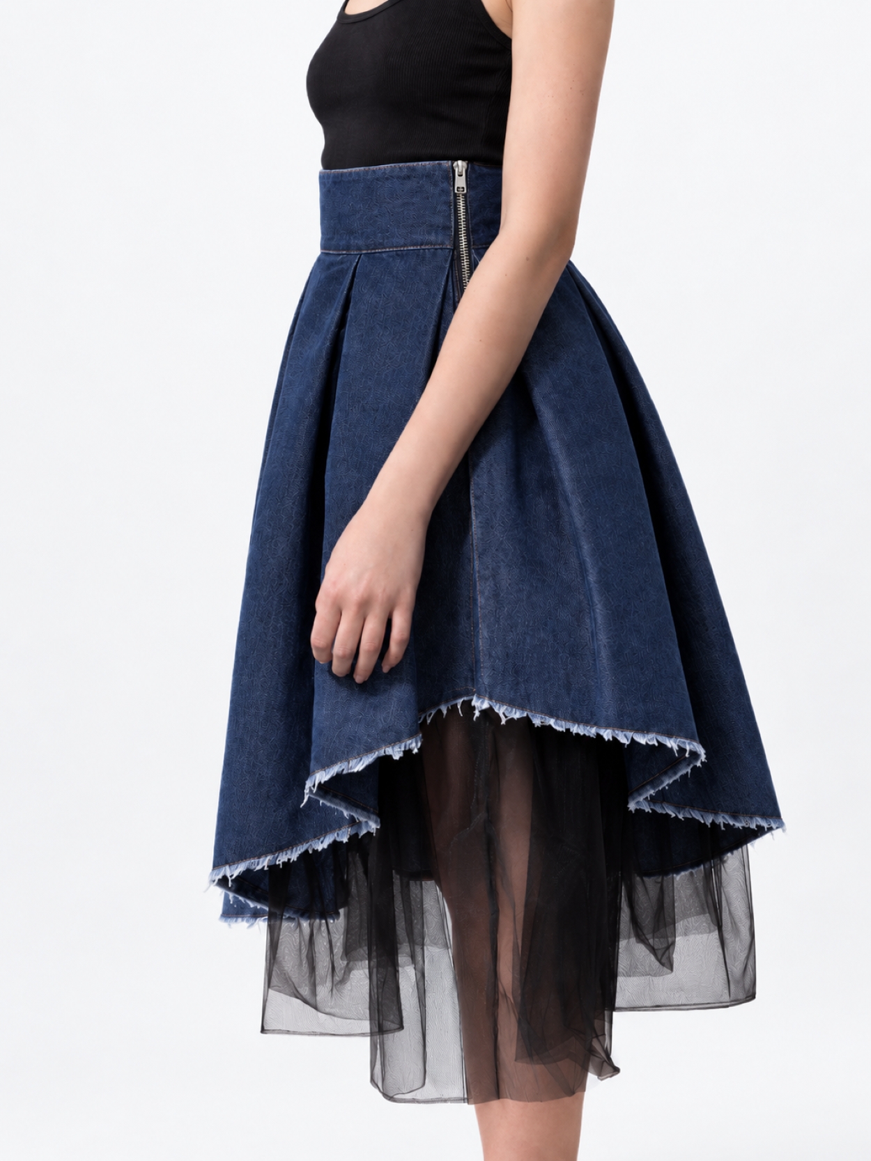 Model wearing BIBI SAKALIEVA asymmetric pleated indigo denim midi skirt with black tulle